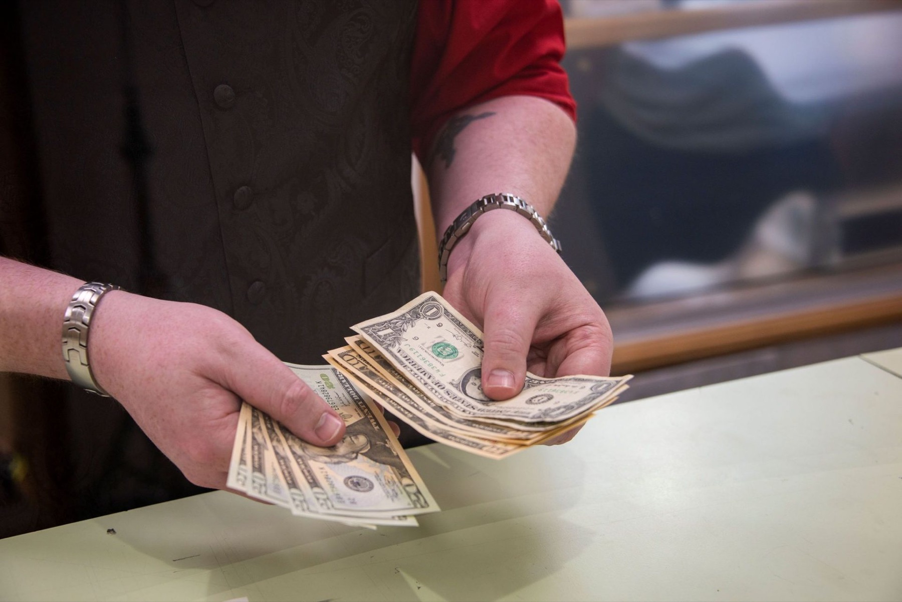 Cash being counted out across the counter